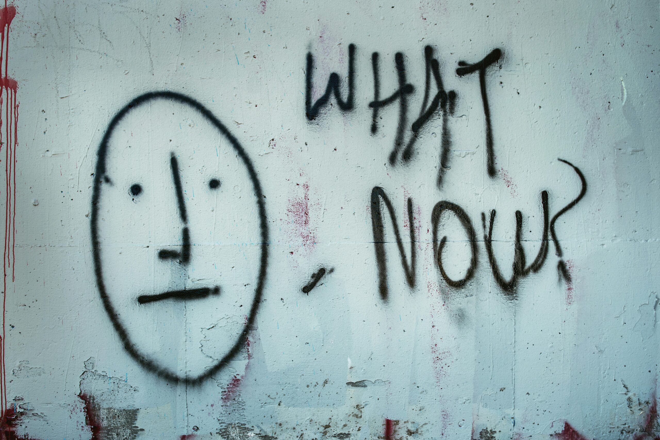 Graphic of grafitti that says "what now?"